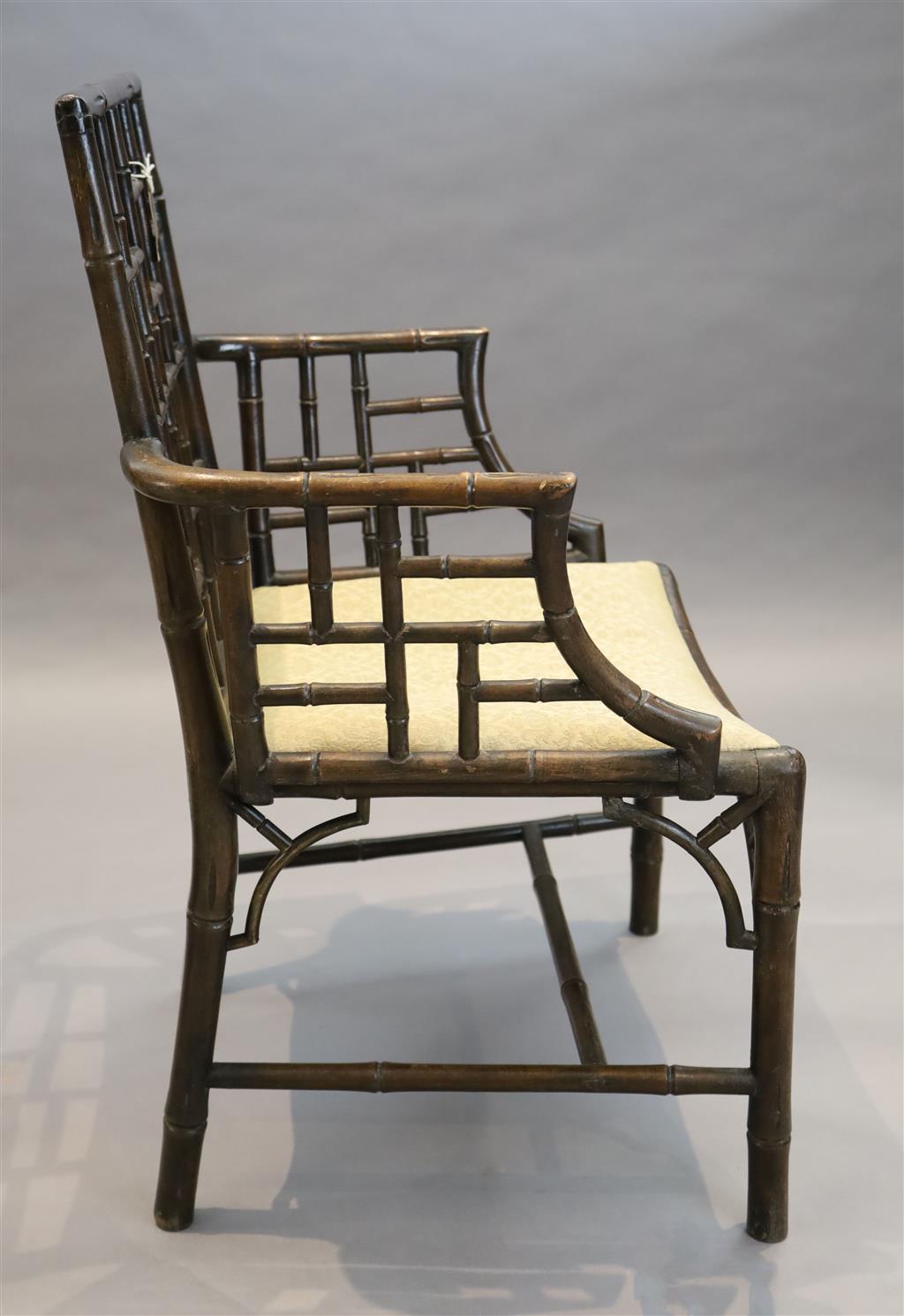 A set of four George III stained mahogany and beech simulated bamboo cockpen elbow chairs, W.2ft 2in. D.1ft 8in. H.3ft 1.5in.